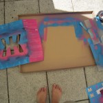 Spraypainting the boxes with stencils